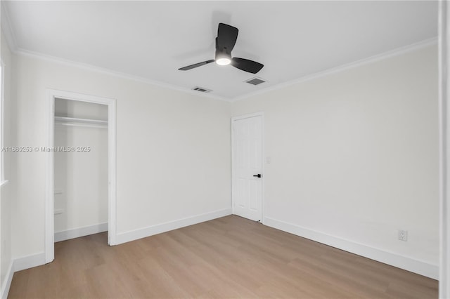 unfurnished bedroom featuring light wood-type flooring, visible vents, and crown molding