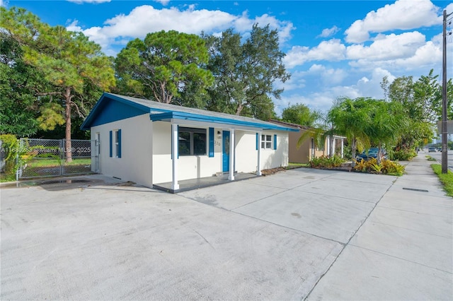 ranch-style home with fence and stucco siding