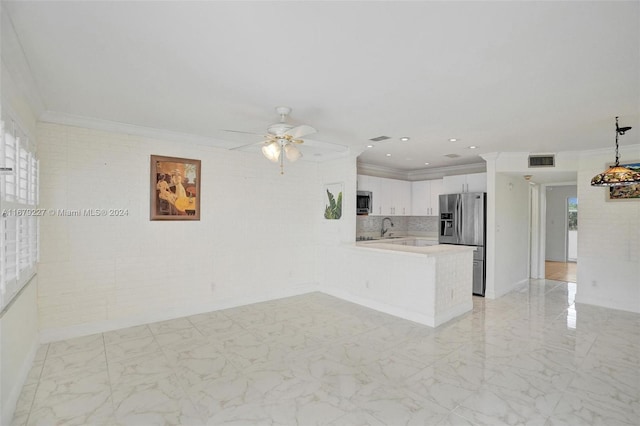 kitchen featuring kitchen peninsula, white cabinetry, stainless steel appliances, and crown molding