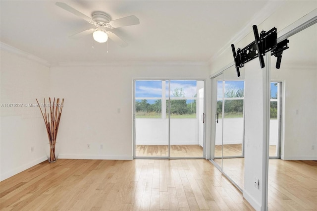 spare room with ornamental molding, light wood-type flooring, and ceiling fan