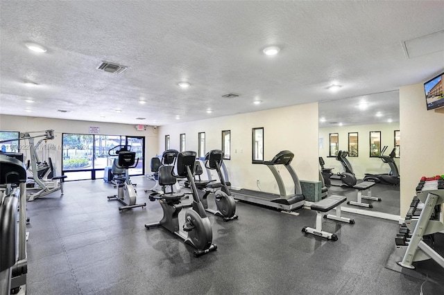 exercise room with a textured ceiling