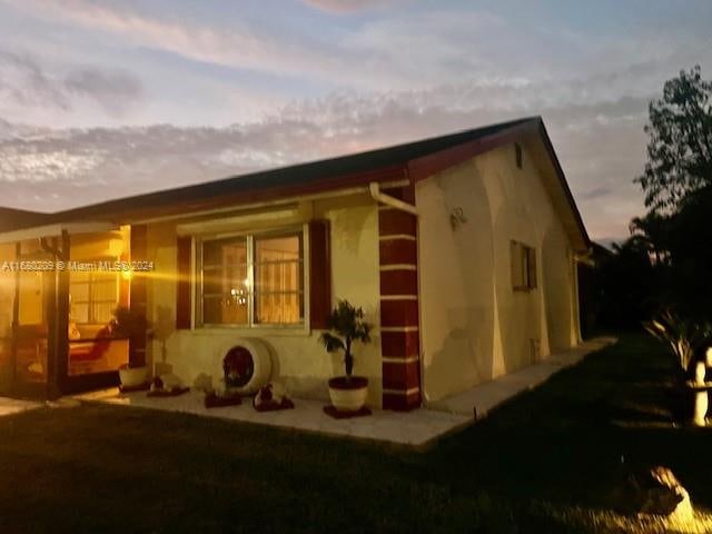 view of back house at dusk