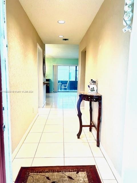 hallway featuring tile patterned flooring