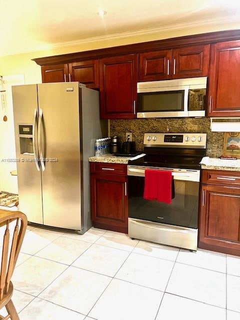 kitchen featuring decorative backsplash, stainless steel appliances, crown molding, light tile patterned floors, and light stone counters