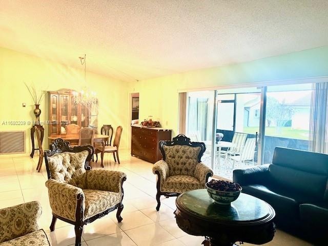 living room with a textured ceiling and light tile patterned floors