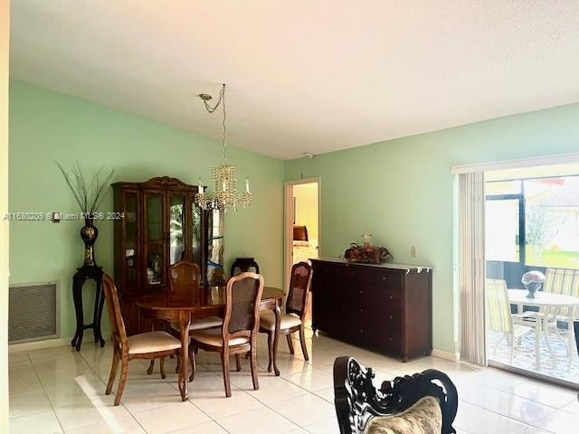 dining room featuring a notable chandelier and light tile patterned floors