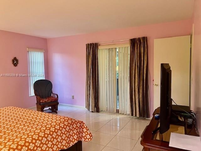 bedroom with light tile patterned floors