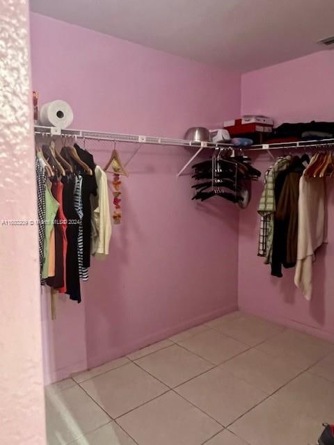 spacious closet featuring light tile patterned floors