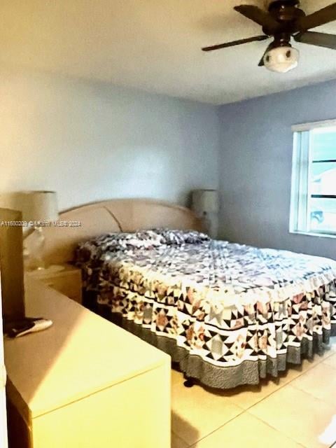 bedroom featuring tile patterned flooring and ceiling fan