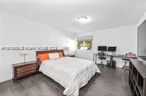 bedroom with dark wood-type flooring