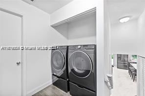 washroom with washing machine and clothes dryer