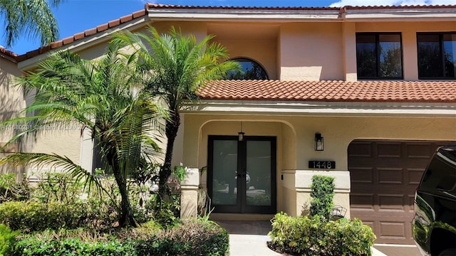 doorway to property featuring french doors and a garage