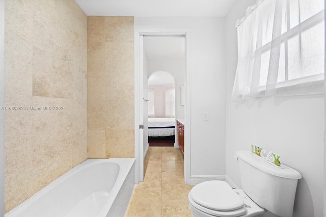 bathroom featuring toilet, tile patterned floors, and a washtub