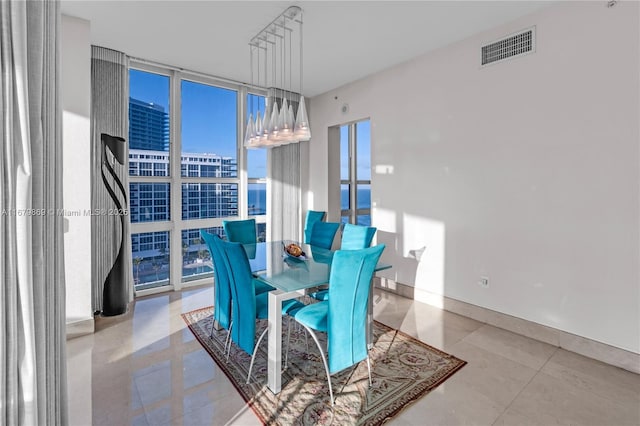 tiled dining room with floor to ceiling windows