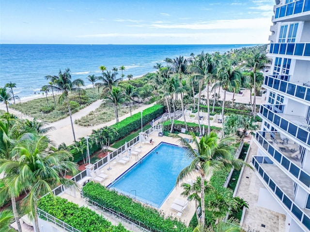 view of pool featuring a patio and a water view