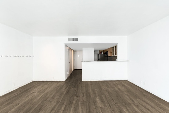 unfurnished living room featuring dark wood-type flooring