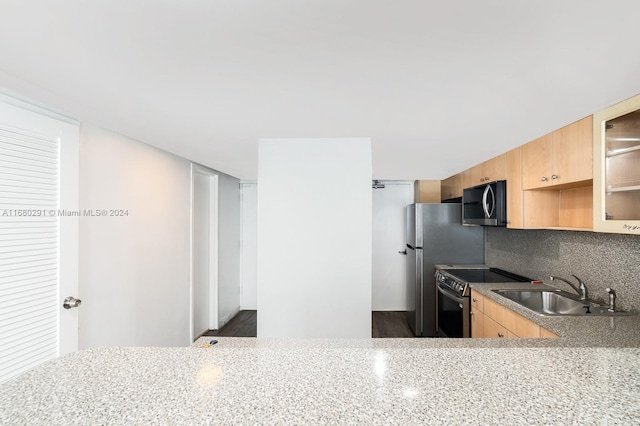 kitchen with light brown cabinetry, sink, appliances with stainless steel finishes, and backsplash