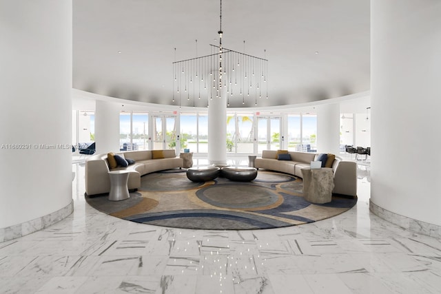 living room with a towering ceiling and a chandelier