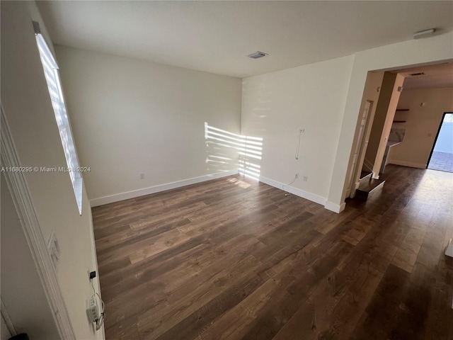 spare room with dark wood-type flooring