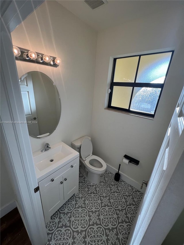 bathroom with tile patterned floors, vanity, and toilet