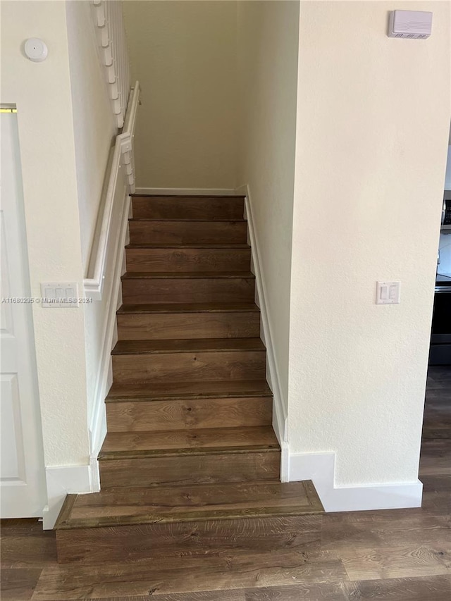 stairway with hardwood / wood-style flooring