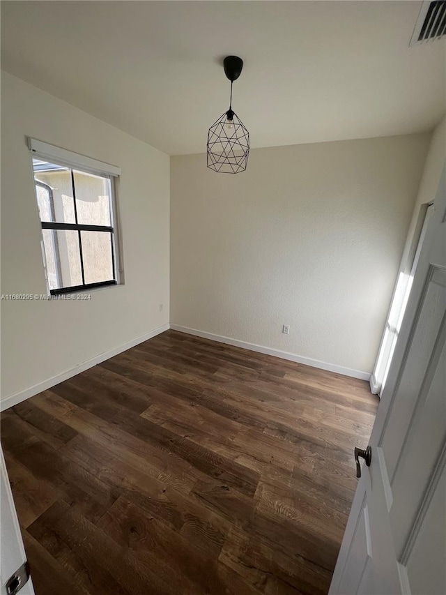 spare room featuring dark hardwood / wood-style floors