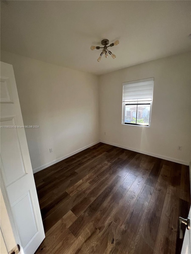 empty room featuring dark wood-type flooring