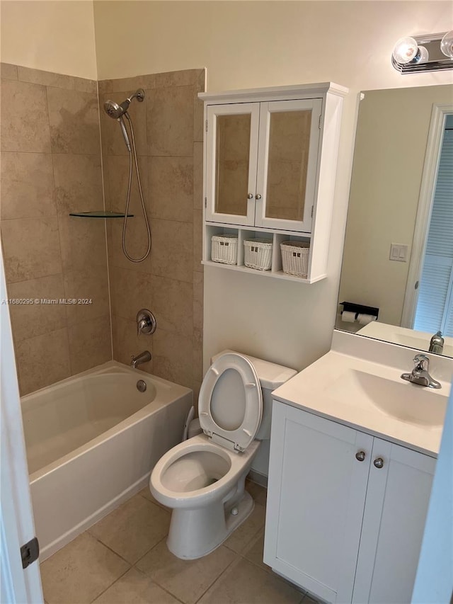 full bathroom featuring tile patterned floors, vanity, toilet, and tiled shower / bath