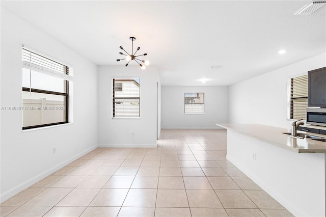 interior space featuring an inviting chandelier, sink, and light tile patterned floors