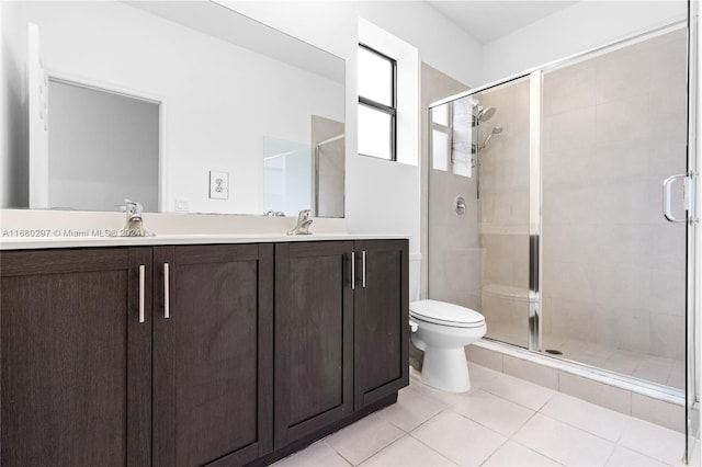 bathroom featuring vanity, toilet, tile patterned floors, and a shower with door