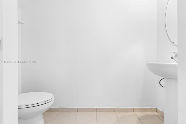 bathroom with toilet and tile patterned flooring