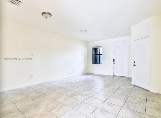 unfurnished room featuring light tile patterned floors