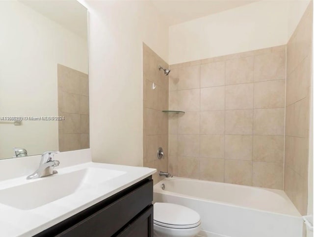 full bathroom featuring vanity, toilet, and tiled shower / bath combo