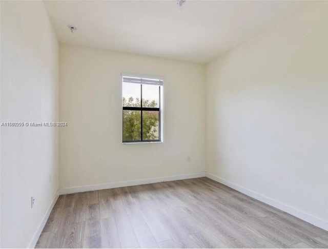 spare room with light hardwood / wood-style flooring