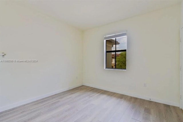 spare room featuring light wood-type flooring