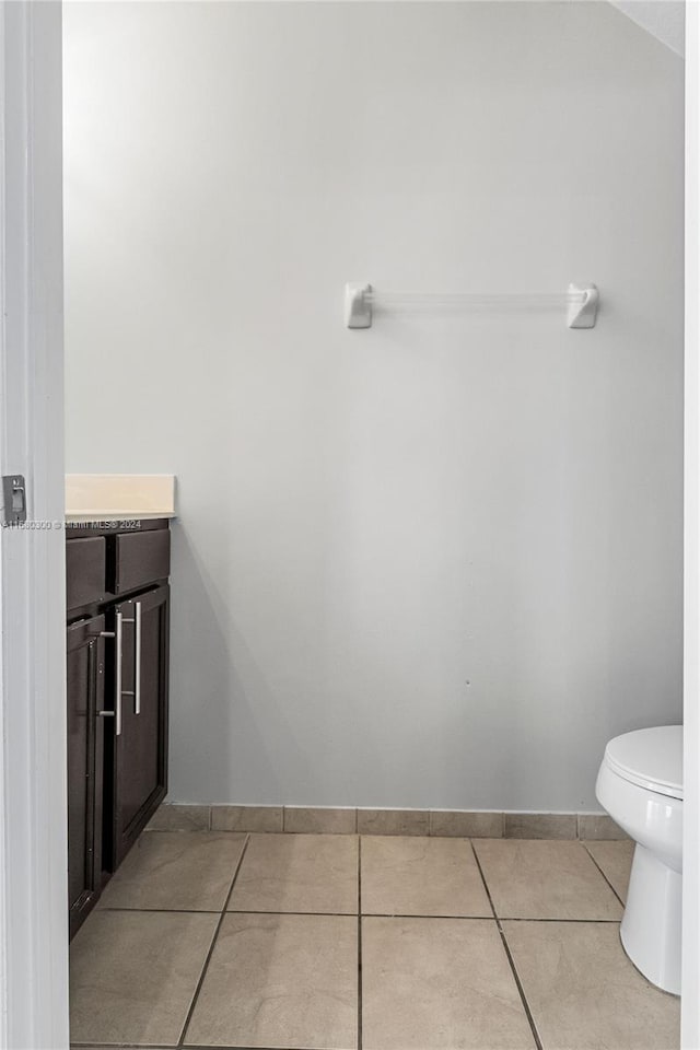 bathroom featuring toilet, vanity, and tile patterned floors