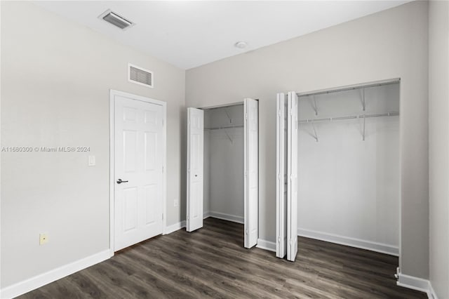 unfurnished bedroom with dark wood-type flooring