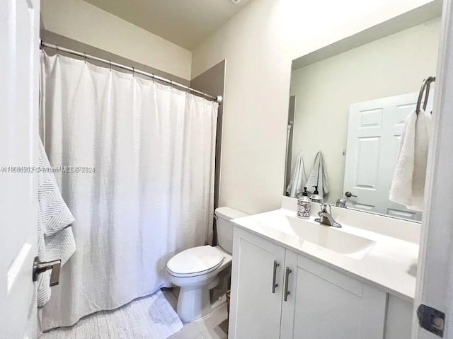 bathroom featuring vanity, toilet, and a shower with shower curtain