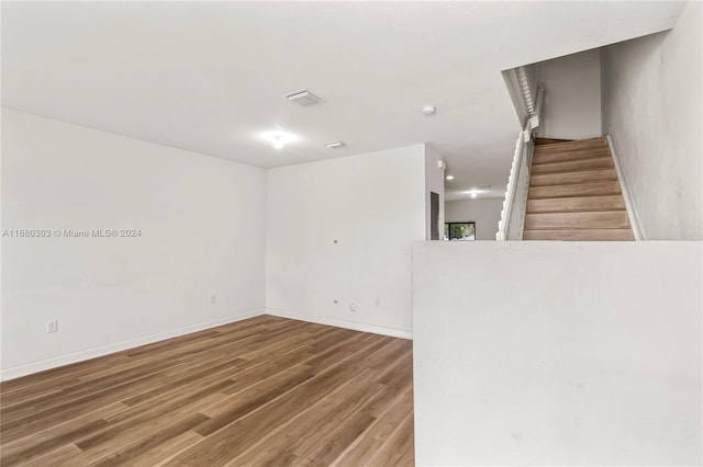 unfurnished room with wood-type flooring