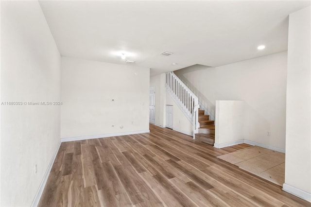 unfurnished room with hardwood / wood-style flooring