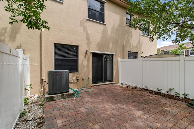 back of property with a patio area and central AC unit