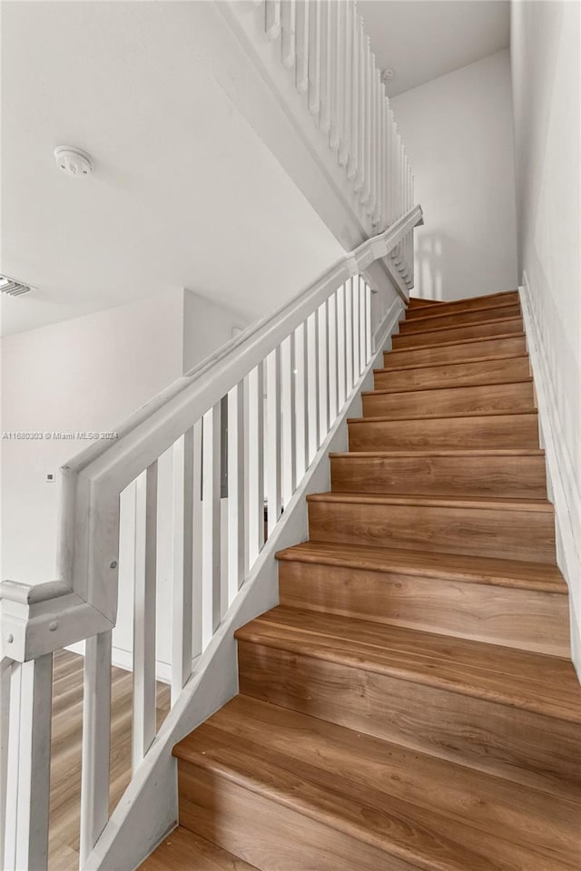 stairs featuring wood-type flooring