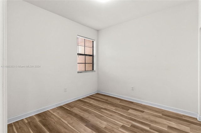 unfurnished room with wood-type flooring