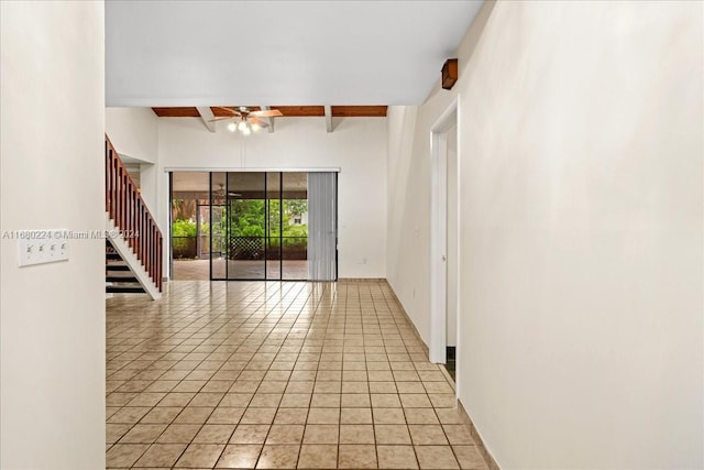 hall featuring beam ceiling and light tile patterned floors