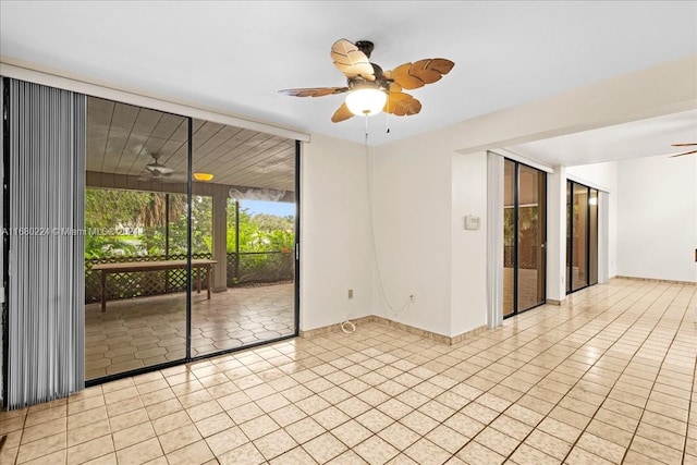 tiled spare room featuring ceiling fan