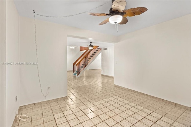 tiled spare room featuring ceiling fan