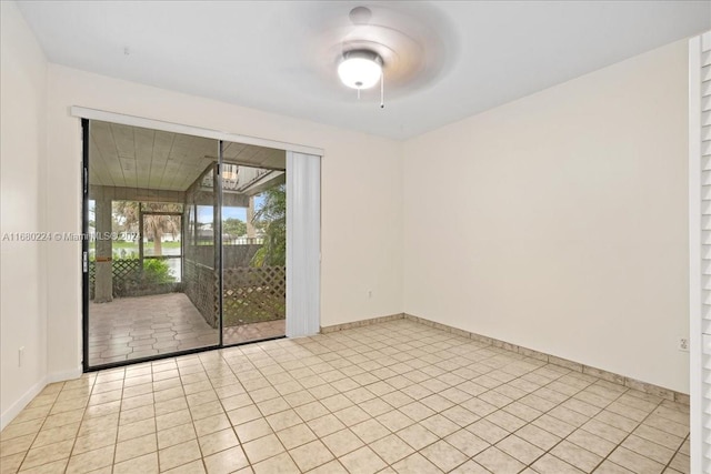 empty room with light tile patterned floors and ceiling fan