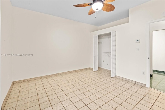 unfurnished bedroom with ceiling fan, light tile patterned floors, and a closet