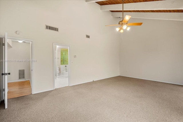 spare room with carpet, ceiling fan, beamed ceiling, and high vaulted ceiling