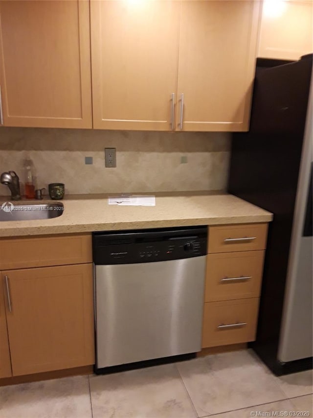 kitchen featuring decorative backsplash, appliances with stainless steel finishes, and light tile patterned flooring